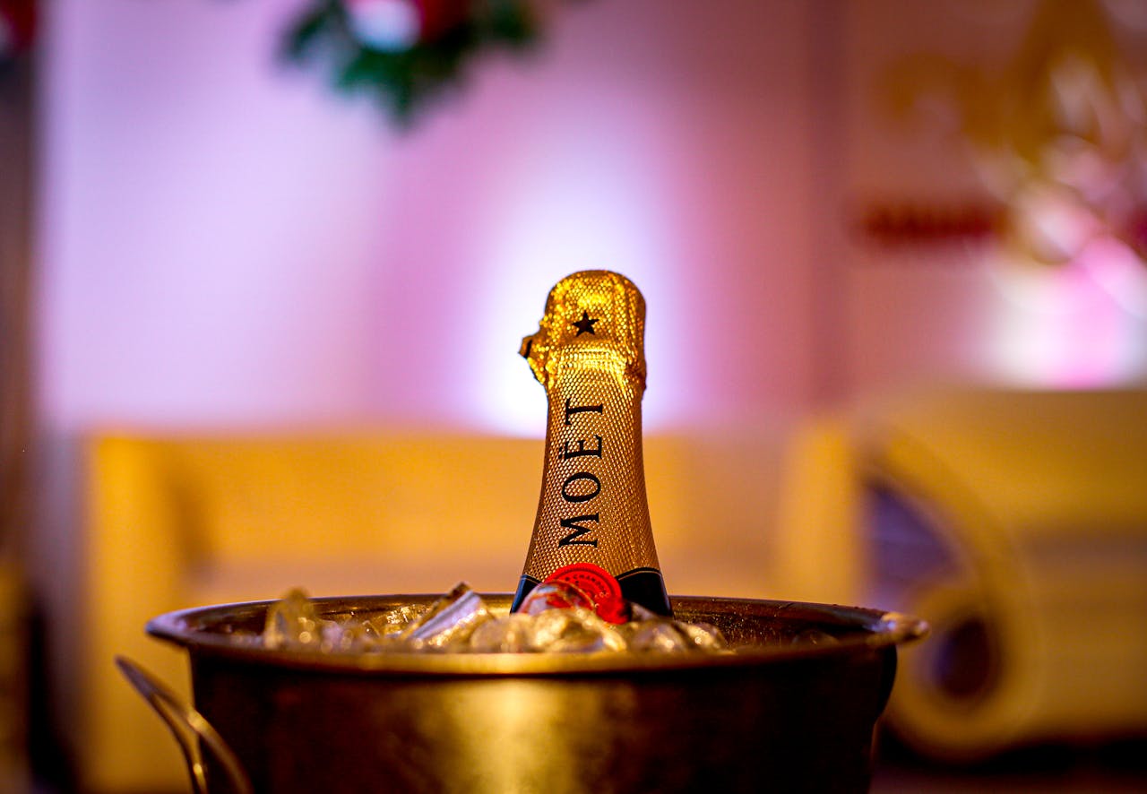 A luxurious champagne bottle chilling in an ice bucket, perfect for celebrations and special occasions.